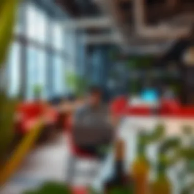 Thriving Work Environment for Freelancers Freelancer working on a laptop in a vibrant co-working space